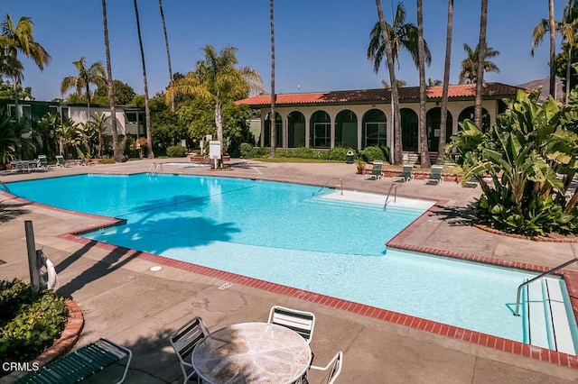 community pool with a patio area