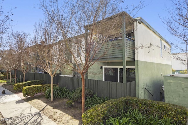 view of side of property featuring fence