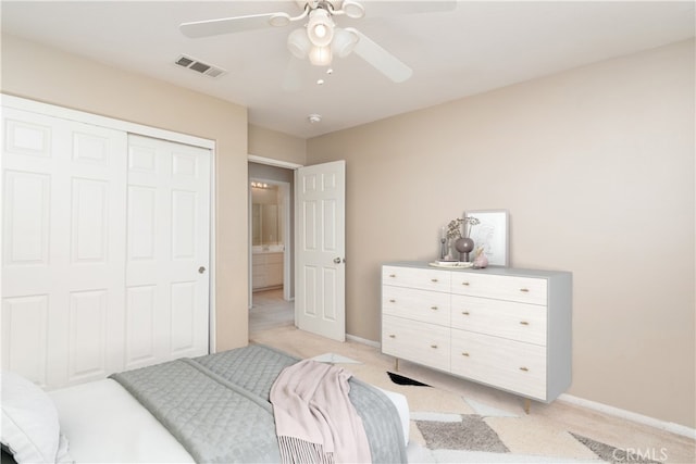 bedroom with a ceiling fan, baseboards, visible vents, a closet, and light carpet