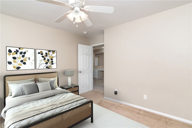 bedroom featuring light colored carpet, a ceiling fan, and baseboards