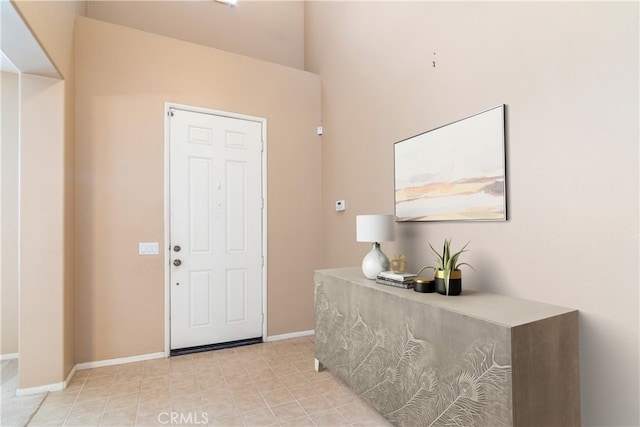 foyer featuring baseboards