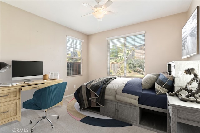 bedroom with baseboards, light colored carpet, and ceiling fan