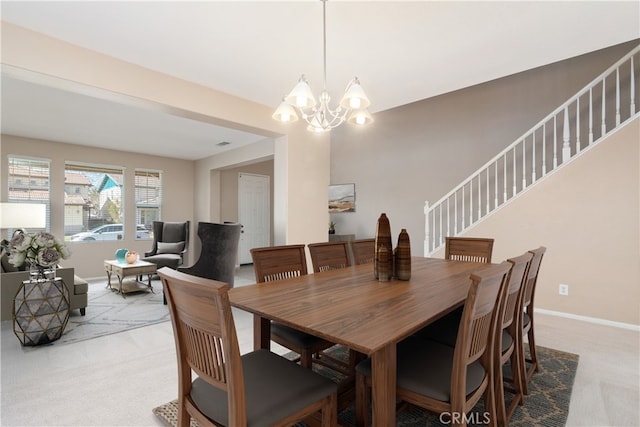 dining room featuring stairway, baseboards, a chandelier, and light carpet