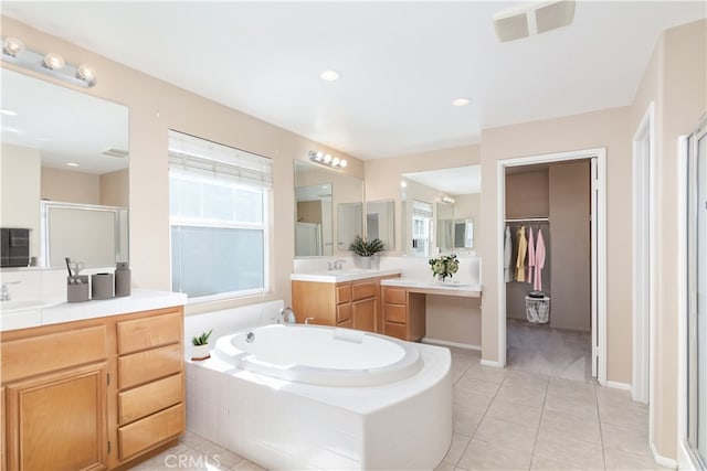 bathroom with visible vents, tile patterned floors, a stall shower, a bath, and vanity