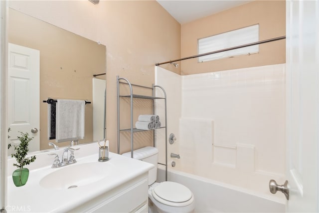 bathroom featuring vanity, toilet, and washtub / shower combination