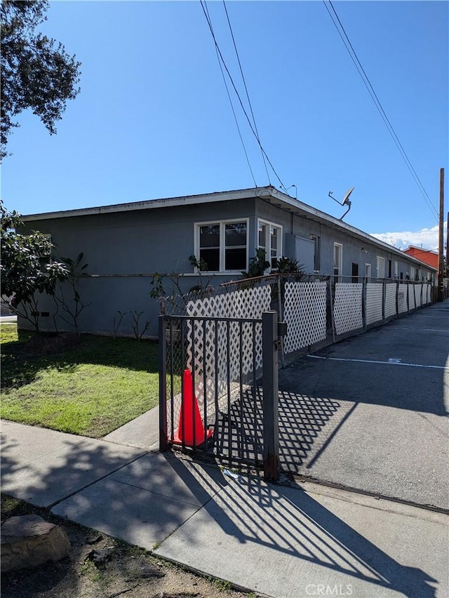 view of home's exterior featuring a yard and fence