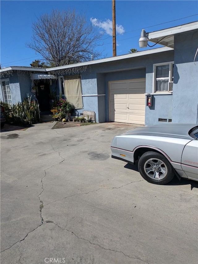 exterior space with stucco siding and a garage