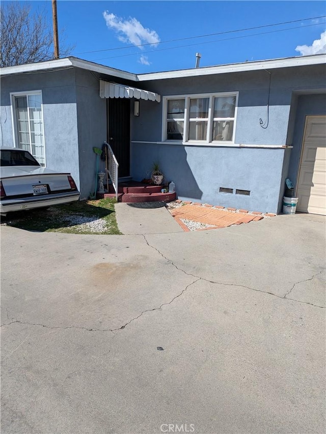 view of front of property with crawl space and stucco siding