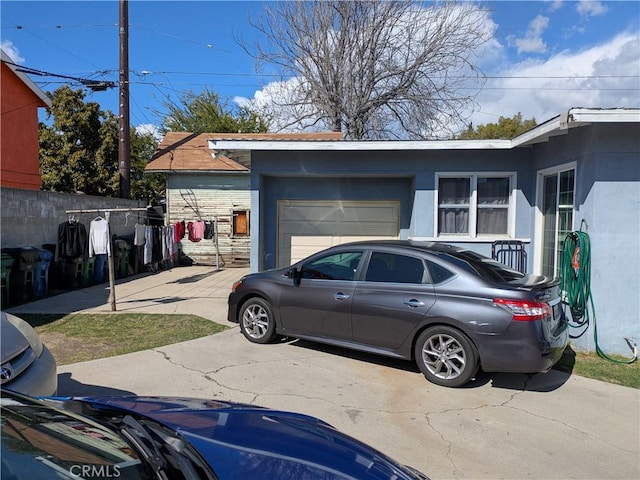 garage with driveway and fence