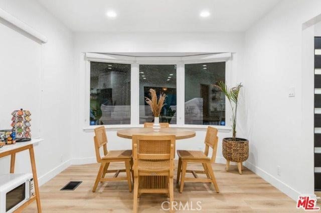 dining area with recessed lighting, visible vents, baseboards, and wood finished floors