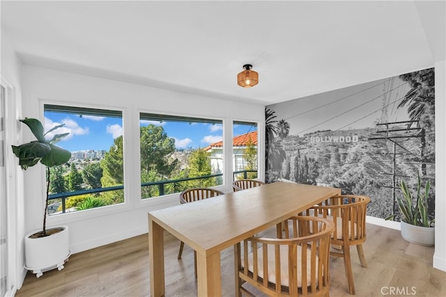 dining room with light wood finished floors and baseboards