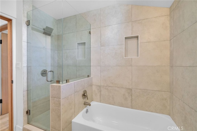 bathroom featuring a garden tub and a shower stall