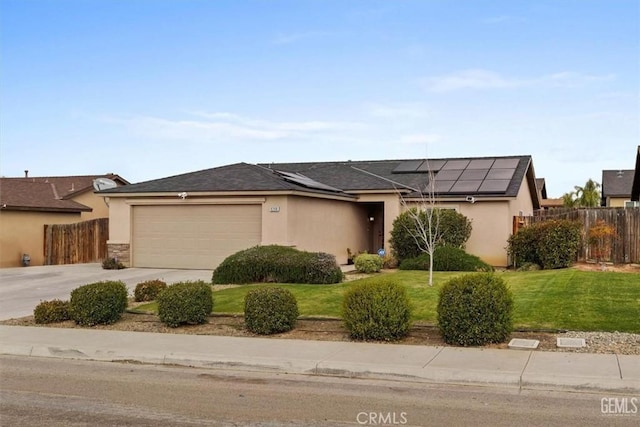 ranch-style house with stucco siding, a front lawn, roof mounted solar panels, fence, and a garage