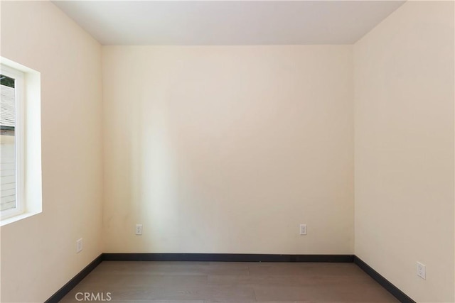 spare room with baseboards