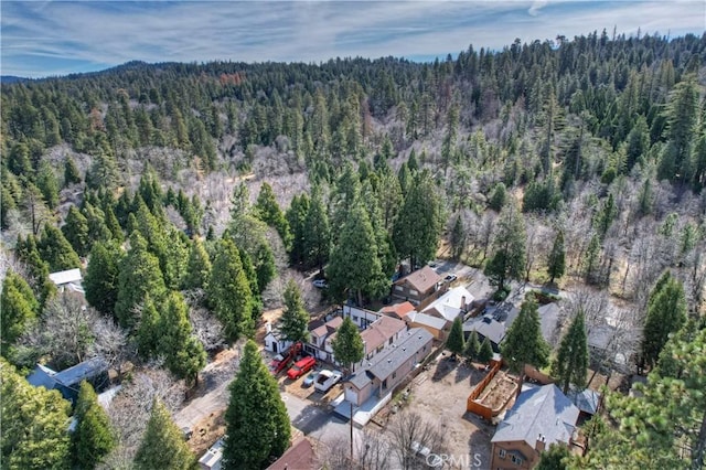 drone / aerial view with a wooded view