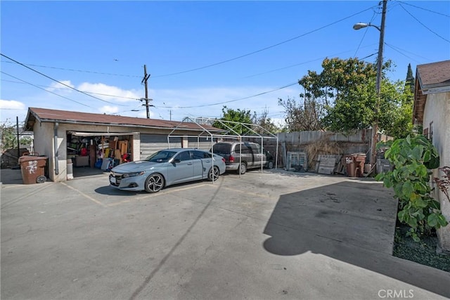 view of car parking featuring fence