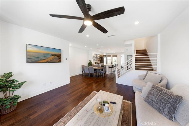 living area featuring visible vents, baseboards, stairway, recessed lighting, and hardwood / wood-style flooring