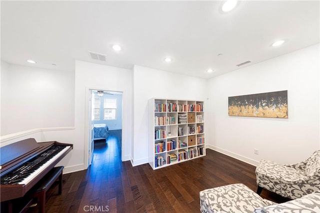 living area with recessed lighting, wood finished floors, and visible vents