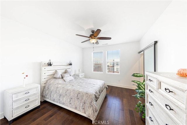 bedroom featuring ceiling fan, dark wood-type flooring, and baseboards