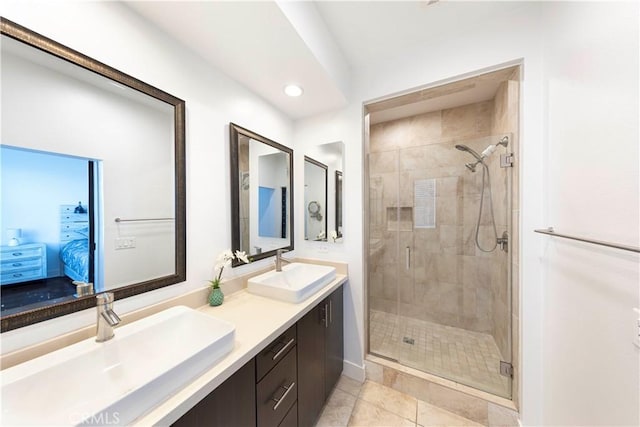 full bath featuring a sink, ensuite bathroom, a shower stall, and tile patterned flooring