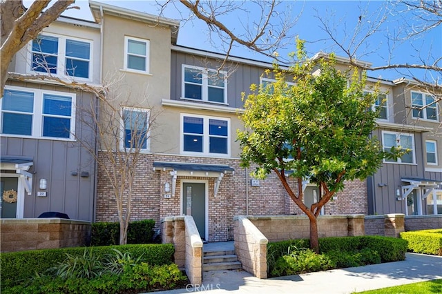 multi unit property with brick siding and stucco siding