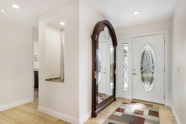 entryway with recessed lighting, baseboards, and wood finished floors