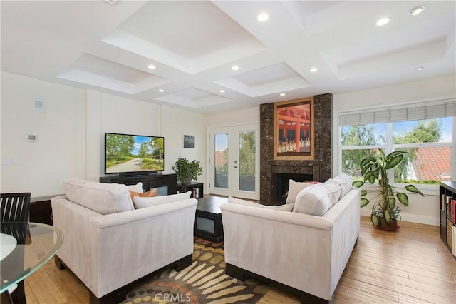 living room with plenty of natural light, coffered ceiling, and wood finished floors