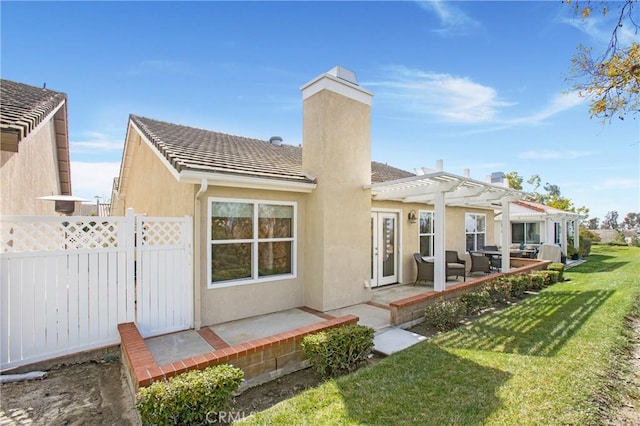 rear view of property with stucco siding, a pergola, a patio, and fence