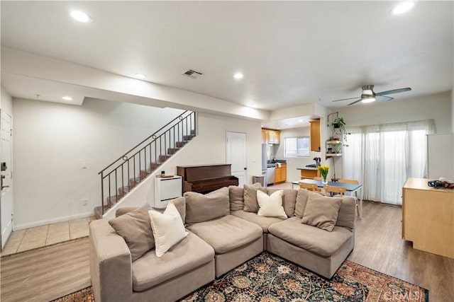 living room with stairway, recessed lighting, light wood-style floors, and visible vents