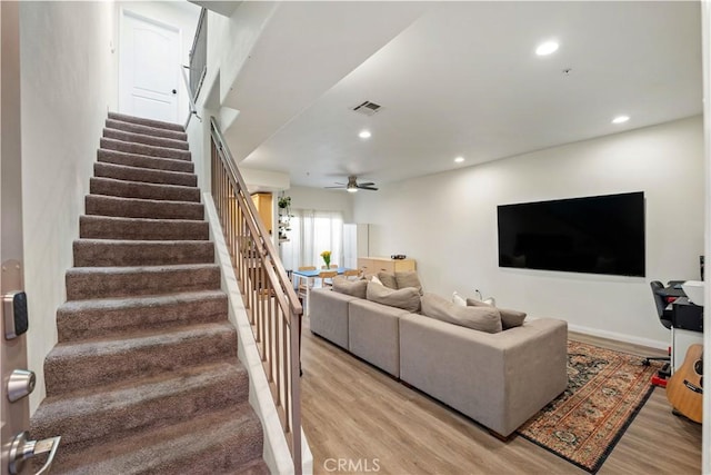 living room featuring visible vents, recessed lighting, stairway, and light wood-style floors