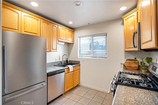 kitchen featuring light tile patterned floors, baseboards, recessed lighting, a sink, and stainless steel appliances