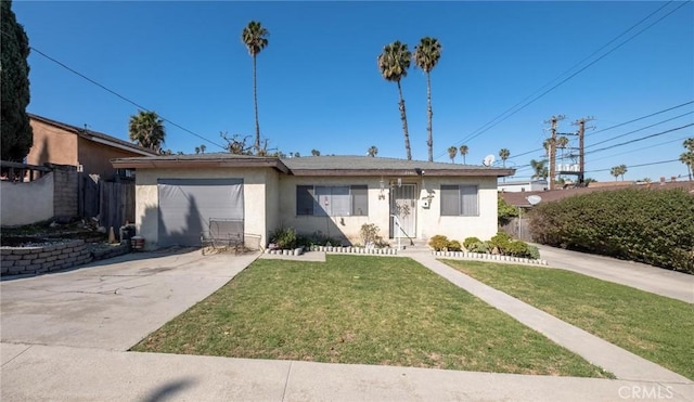 view of front of house with a front lawn, fence, stucco siding, a garage, and driveway