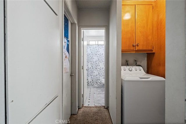 clothes washing area featuring washer / clothes dryer, carpet, and cabinet space