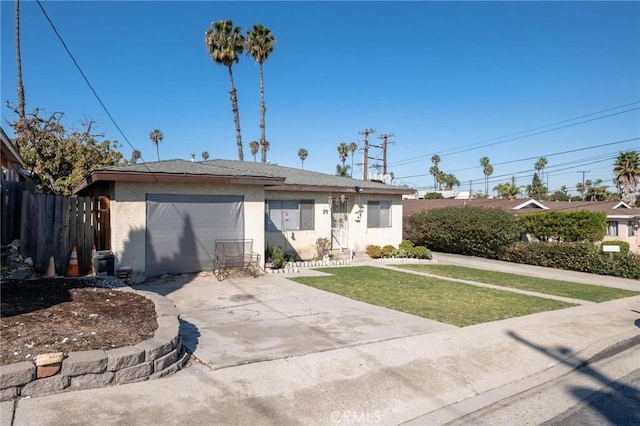 single story home featuring a front yard, fence, driveway, an attached garage, and stucco siding