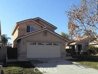 traditional-style house with a garage and driveway