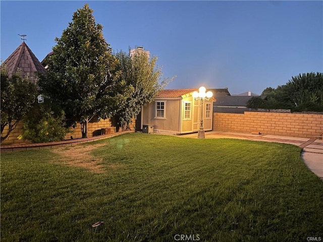 view of yard featuring an outdoor structure and fence