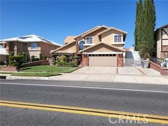 view of front of property featuring concrete driveway and a garage