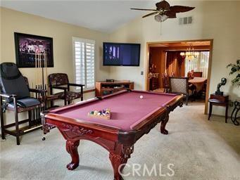 game room featuring lofted ceiling, a ceiling fan, visible vents, and carpet floors