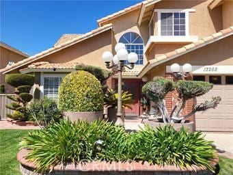 exterior space featuring a garage, driveway, and stucco siding