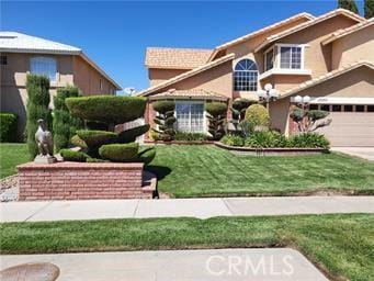 view of front of house with a garage and a front lawn