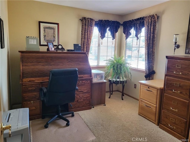 carpeted office featuring baseboards