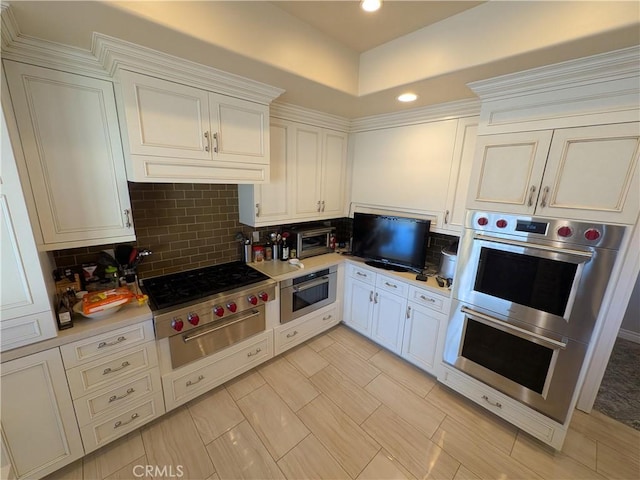 kitchen featuring tasteful backsplash, white cabinetry, recessed lighting, appliances with stainless steel finishes, and light countertops