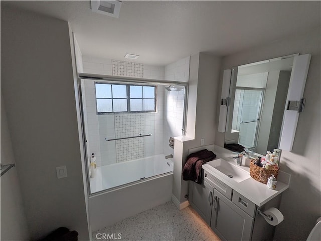 bathroom featuring vanity, visible vents, speckled floor, shower / bath combination with glass door, and baseboards