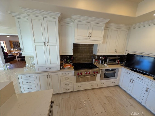 kitchen with decorative backsplash, white cabinets, a toaster, and oven