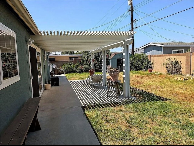 view of yard featuring a patio area, a pergola, and fence