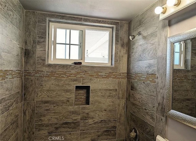 full bathroom featuring tiled shower