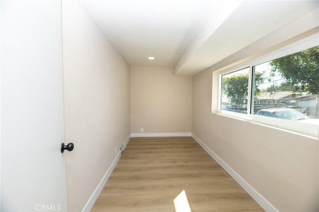 empty room featuring recessed lighting, light wood-style floors, and baseboards