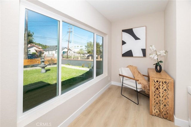 interior space with baseboards and wood finished floors