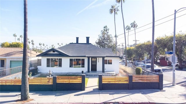 bungalow featuring a fenced front yard