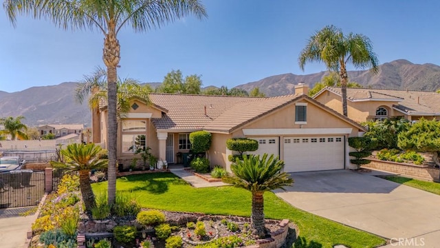 view of front of property featuring stucco siding, fence, a mountain view, concrete driveway, and a garage